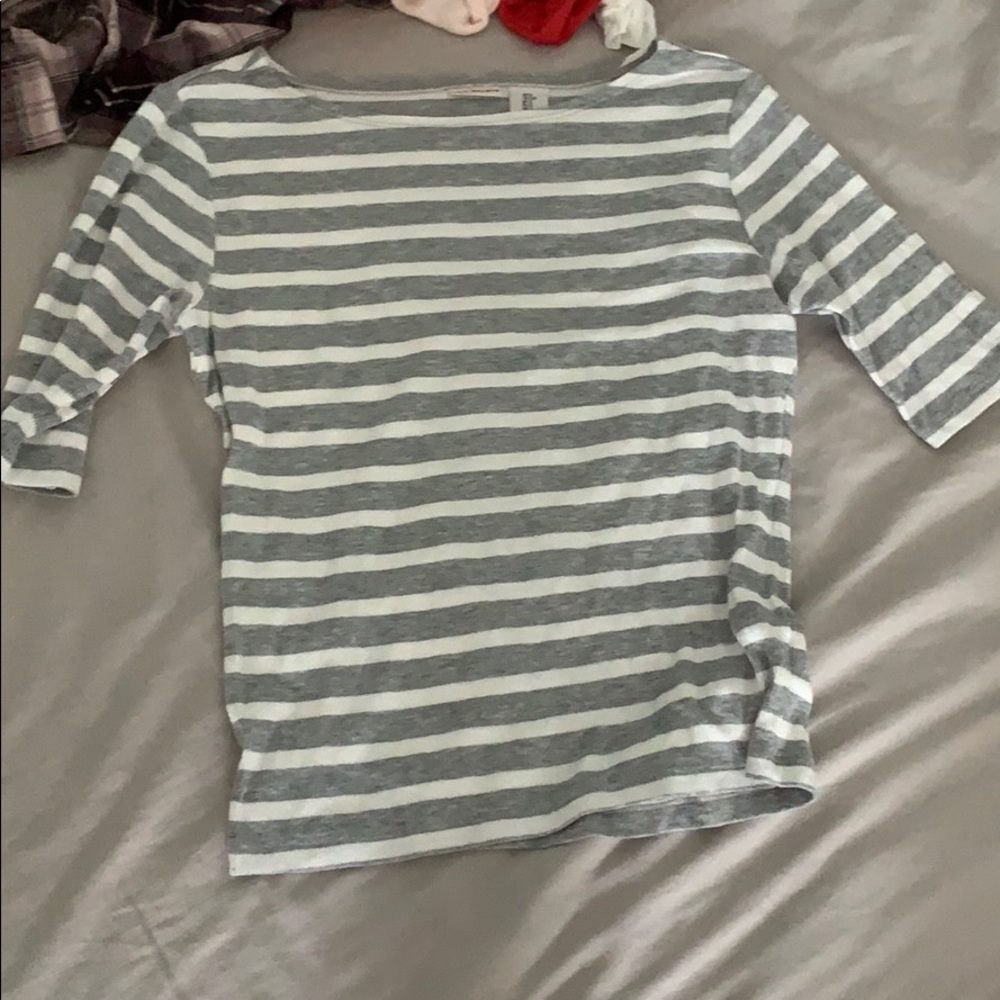 grey and white striped shirt. quarter long sleeve